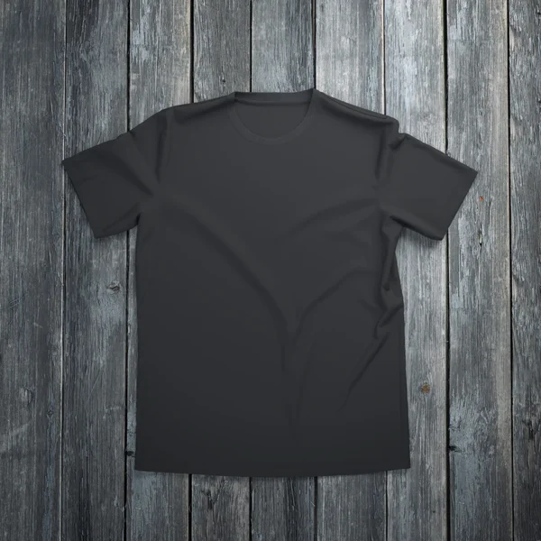 T-shirt preta em fundo de madeira — Fotografia de Stock