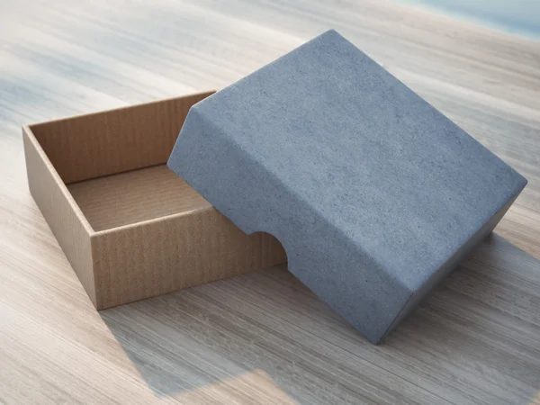 Open box on wooden table — Stock Photo, Image