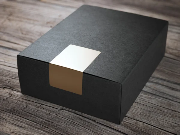 Caja negra con pegatina dorada — Foto de Stock