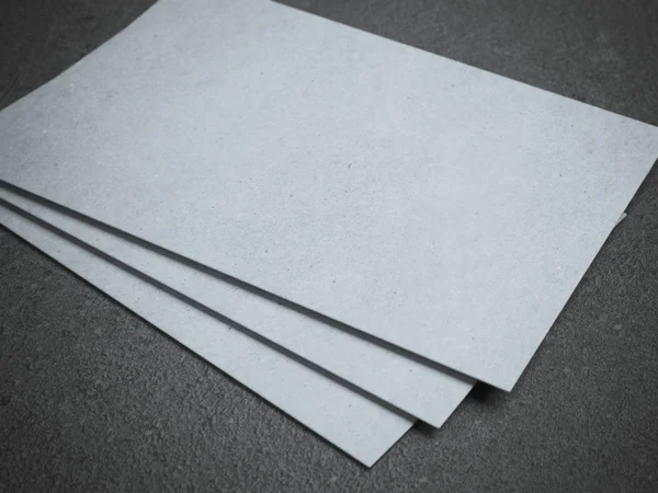 Three white business cards on gray floor — Stock Photo, Image