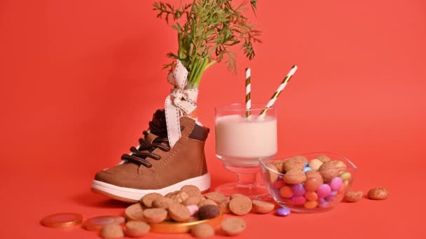 Dutch holiday Sinterklaas. hildrens shoe with carrots for Santas horse, pepernoten and sweets . Gloved hands are rubbed with antiseptic, sanitizer and a protective mask. — Stock Video