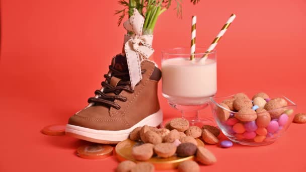 Dutch holiday Sinterklaas. hildrens shoe with carrots for Santas horse, pepernoten and sweets . Gloved hands are rubbed with antiseptic, sanitizer and a protective mask. — Stock Video