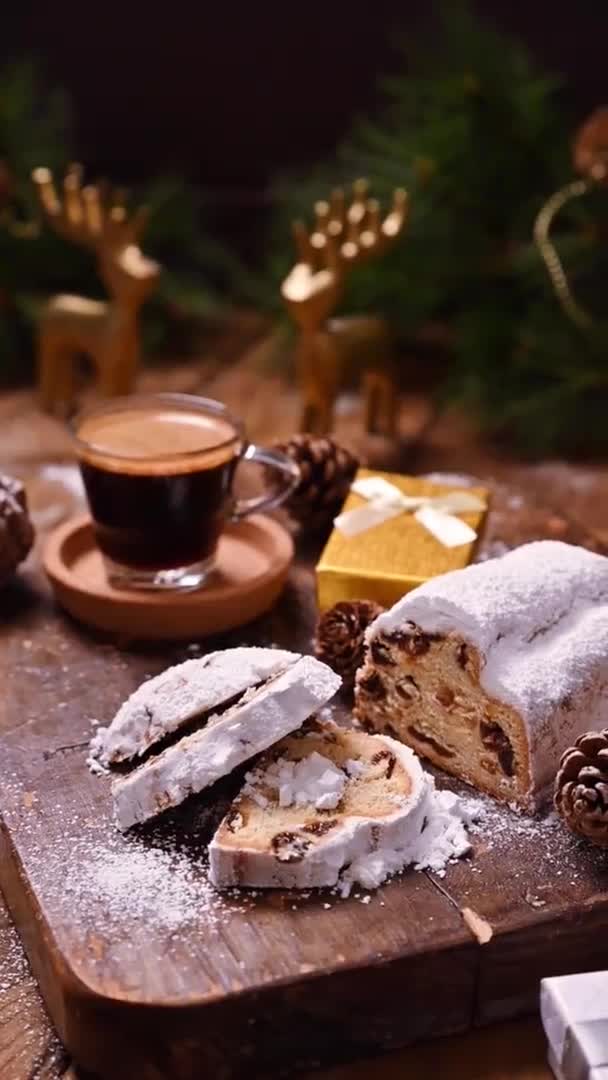 Stollen and aromatic espresso coffee with gift boxes on a wooden background. Traditional German sweet bread with dried fruits and marzipan for Christmas. Top view. Copy space. High quality photo — Stock Video