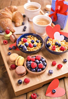 Sabah kahvesi. Romantik bir kahvaltı için romatik kahve, müsli ve tatlı hamur işleri. Sabah için böğürtlenli ve kapuçinolu sağlıklı yiyecekler..