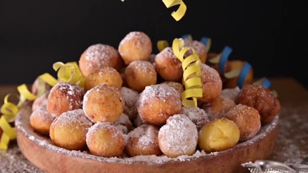 Carnival food TYPICAL and carnival mask. Sfrappole or chiachiere or angel wings and aromatic coffee on a woody background. Traditional sweet crisp pastry deep-fried and sprinkled with powdered sugar — Stock Video