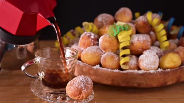 Espresso coffee is poured from a geyser coffee maker. Baked castagnole with powdered sugar. Traditional sweet pastries in hand. Street food, round biscuits with sugar for the carnival of Venice — Stock Video