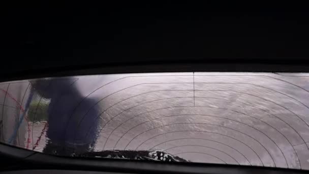 Болонья, Италия 7 февраля 2021 года. Стирание шин на автомойке самообслуживания. Мужчина в защитной маске моет машину. Автосервис. — стоковое видео