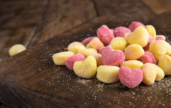 Gnocchi. Traditional Italian pasta with heart-shaped potatoes in different colors. Fresh cooked food from the south of italy. High quality photo. Copy space.