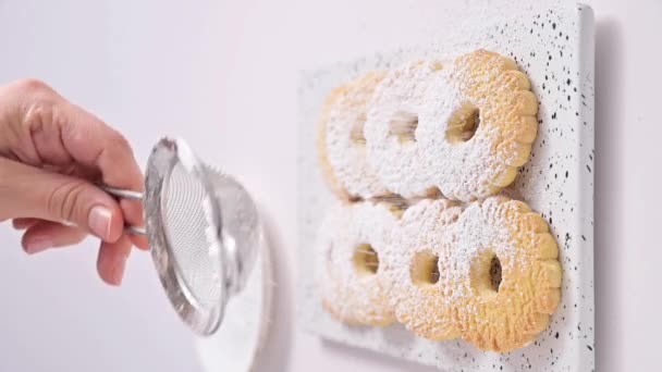 Canestrelli, galletas tradicionales de manzanilla de Liguria con azúcar en polvo. Productos horneados de vacaciones desde el sur de Italia, froll pasta en la mano. Vídeo vertical — Vídeos de Stock