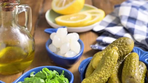 Dutch herring. Toast with Dutch herring, onions, pickles. Traditional rustic appetizer with seafood. Popular food in the netherlands. The hand takes a sandwich. — Stock Video