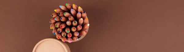 Eco colored pencils made from recycled material. A fence made of wooden pencils. Top view. Free space for text. — Stock Photo, Image