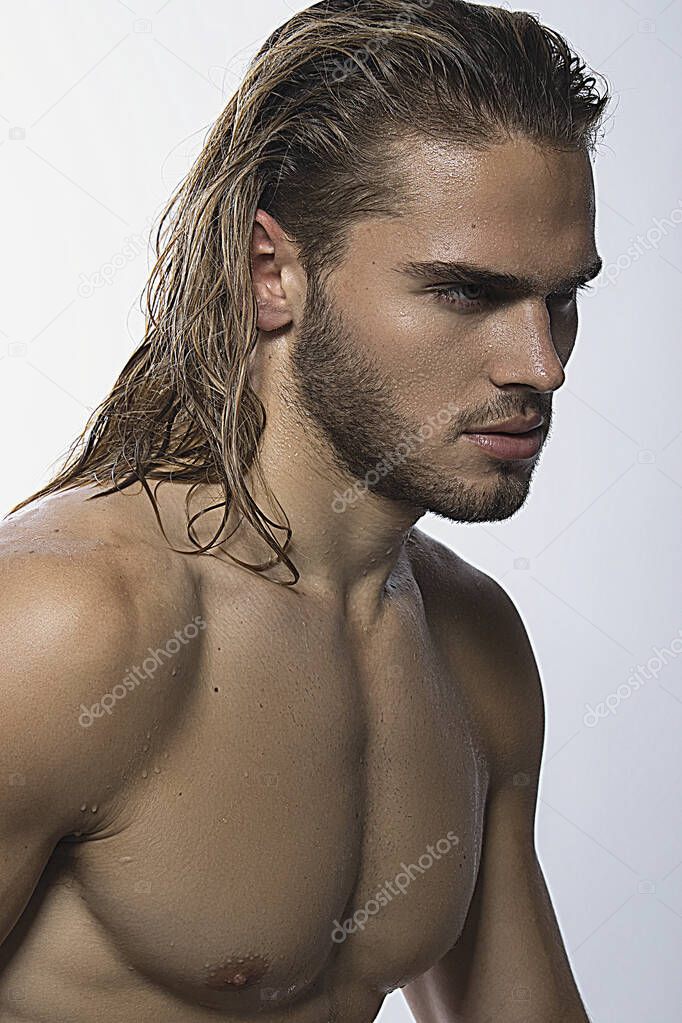 Sexy sport muscle strongface blond guy with long hair in white underwear on white isolated  font background