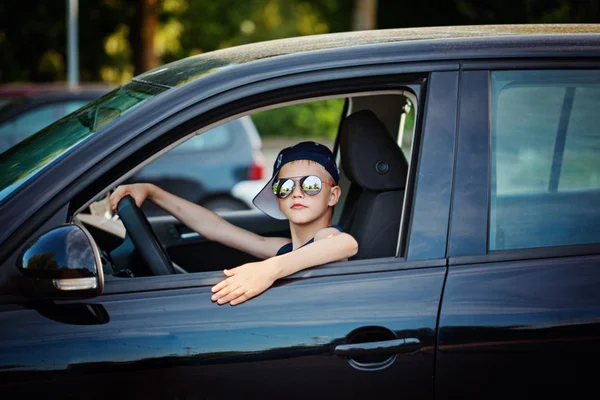 Cute little boy driving fathers car. Happy little boy  sitting in the car. — Stock Photo, Image