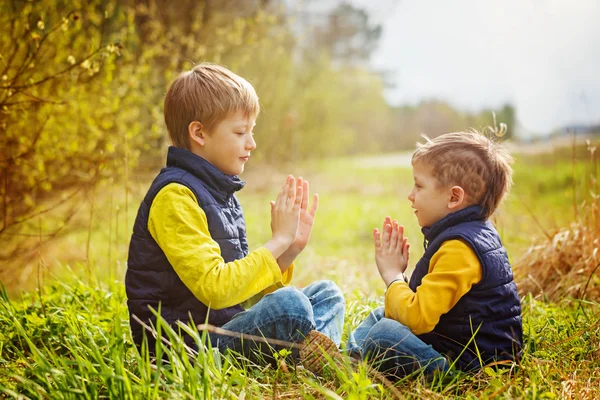 Happy two litte brothers having fun together  at the sunny day t