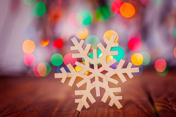 Wooden Snowflake on colorful boke background with copy space, se — Stock Photo, Image