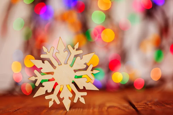 Wooden Snowflake on colorful boke background with copy space, se — Stock Photo, Image