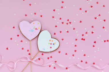 Sevgililer Günü için iki pembe ve beyaz kalp, pembe arka planda anneler günü ya da doğum günü için zencefilli ekmek..