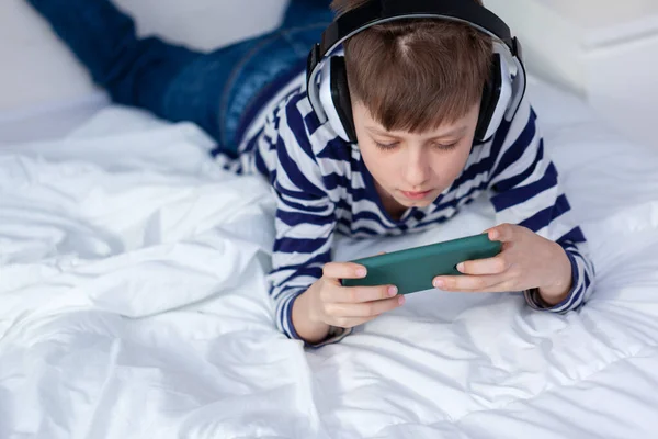 Bambino Ragazzo Cuffia Guardando Giocando Telefono Imparare Sul Letto Soggiorno — Foto Stock