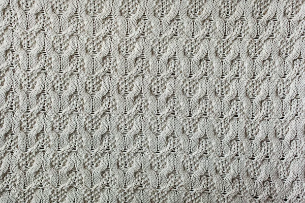 Knitted woolen background, beige texture
