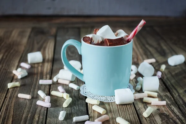 Mug filled with hot chocolate and marshmallow  and candy canes — Stock Photo, Image
