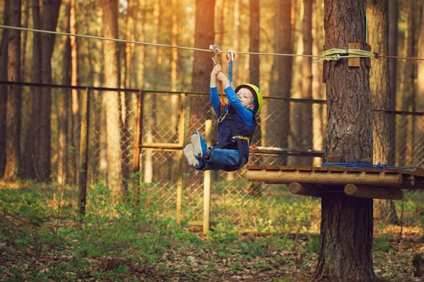 Imádnivaló vidám kis fiú ziplining rövid az erdő — Stock Fotó
