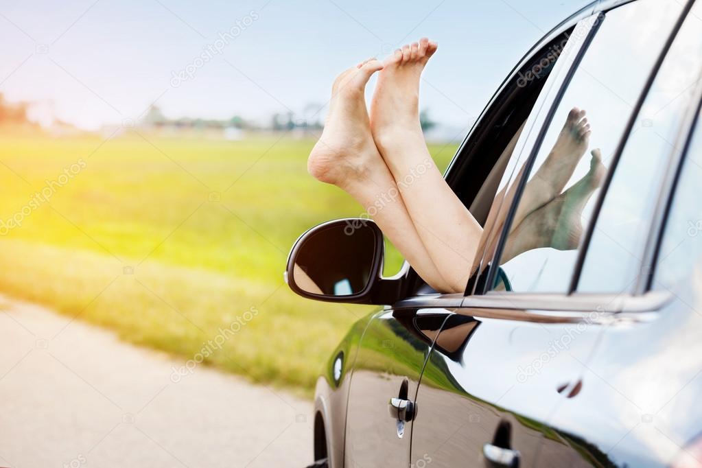 Womans legs out of the car window