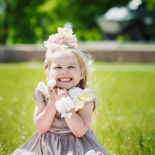 Portrait of smiling girl holding her favourite soft toy in summe — Stok fotoğraf