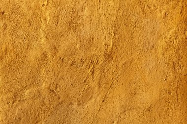 Yellow stucco wall. 