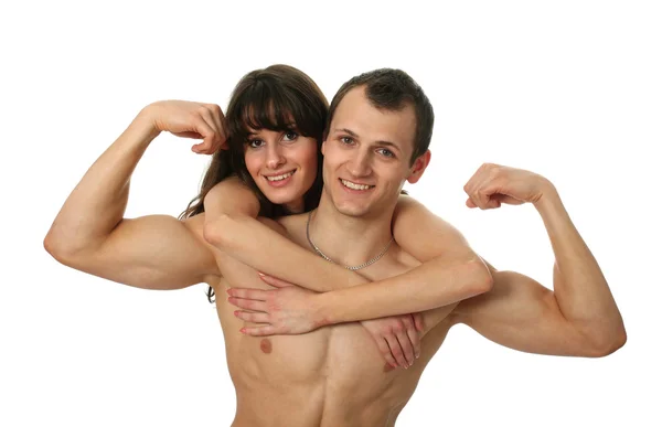 Mulher abraçando seu namorado muscular — Fotografia de Stock