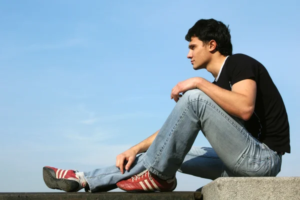 Teenager sitting on the stone blocks — Stock Photo, Image