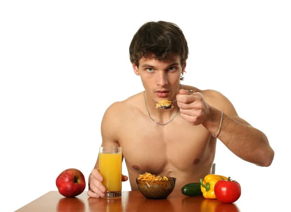 Молодой мускулистый человек ест свой завтрак — стоковое фото