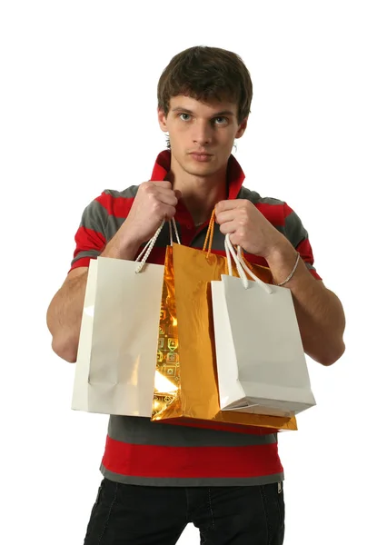 Joven sexy hombre con bolsas de compras —  Fotos de Stock