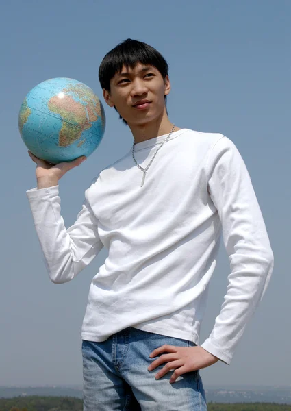 Young Asian Man with a Globe — Stock Photo, Image