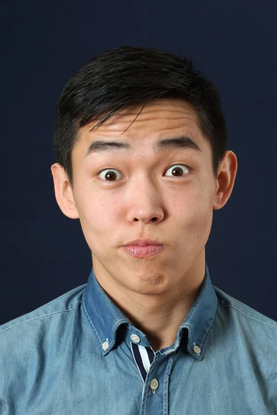 Astonished young Asian man Stock Image