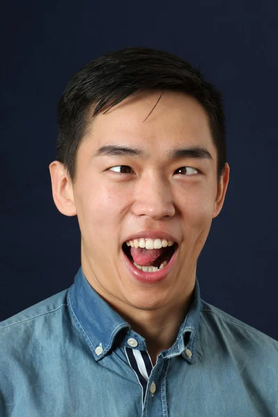 Asian man showing his tongue — Stock Photo, Image