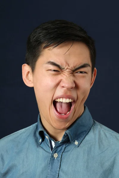 Disgusted young Asian man — Stock Photo, Image