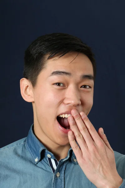 Asian man covering his   mouth — Stock Photo, Image