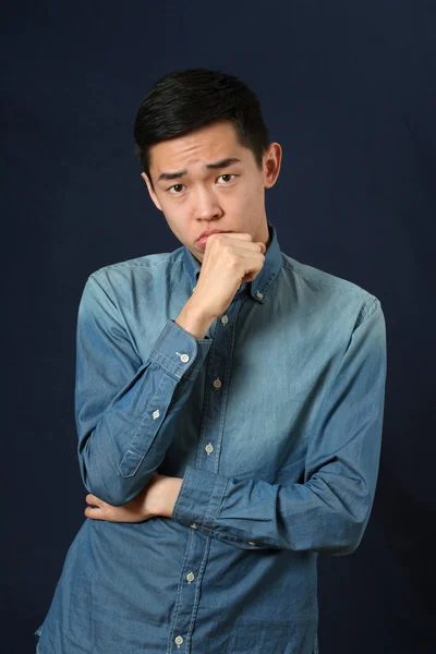 Pensive young Asian man — Stock Photo, Image