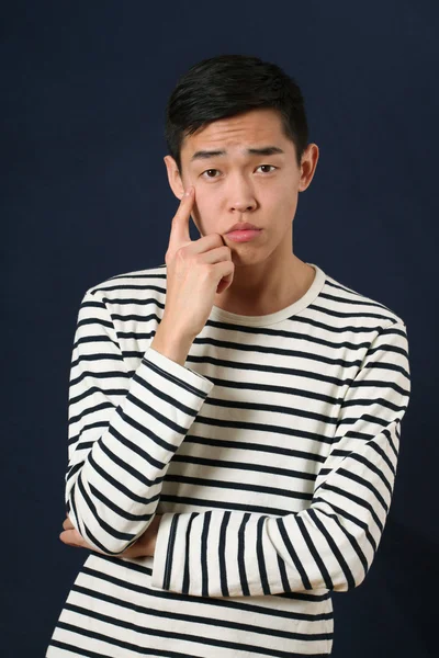 Pensive young Asian man — Stock Photo, Image