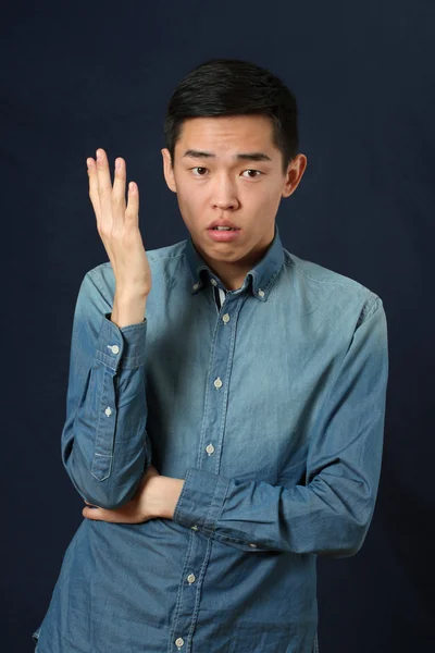 Displeased young Asian man — Stock Photo, Image