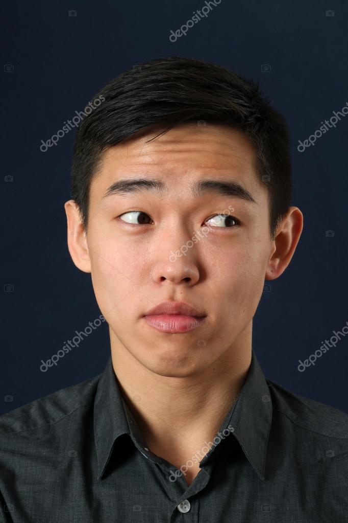 Portrait Of A Young Handsome Asian Man With Blue Eyes And Dark