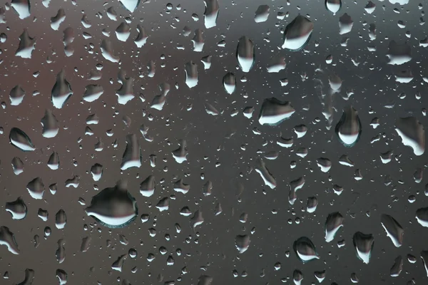 Raindrops on glass as background — Stock Photo, Image