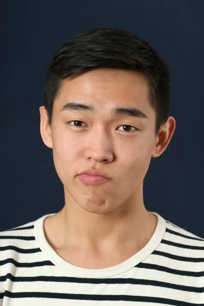 Funny young Asian man making face — Stock Photo, Image