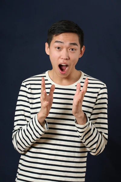 Astonished young Asian man gesturing — Stock Photo, Image