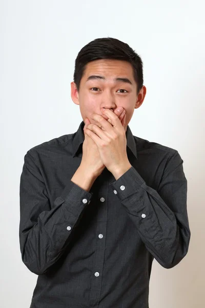 Astonished young Asian man — Stock Photo, Image
