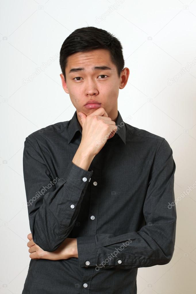 Thinking young Asian man