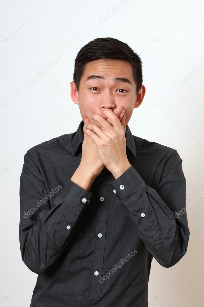 Astonished young Asian man