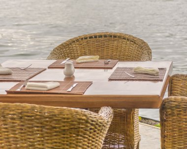 Wicker Chairs an Wood Table at Lake