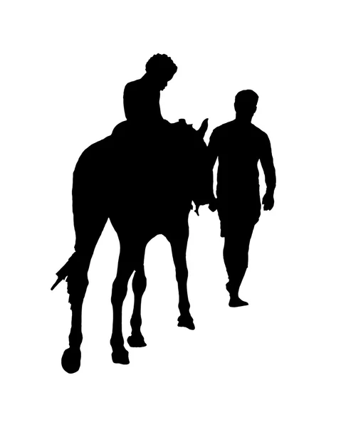 Ребенок на лошади с силуэтом взрослого мужчины — стоковое фото