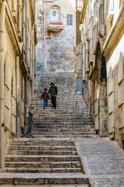 JERUSALEM, ISRAEL, DECEMBER - 2019 - Two kids going down the stairs, old jerusalem city